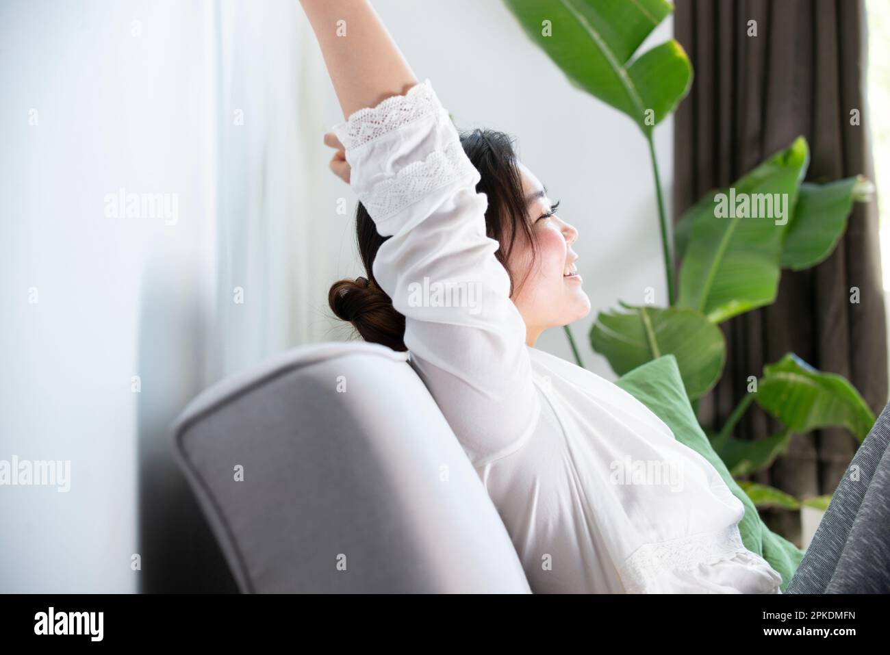 Asian woman on sofa hi-res stock photography and images - Alamy