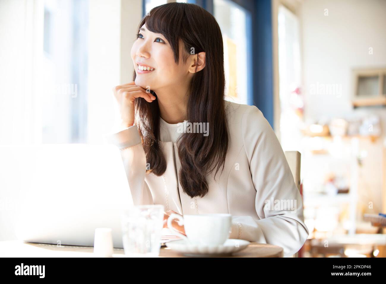 Woman working at a café Stock Photo