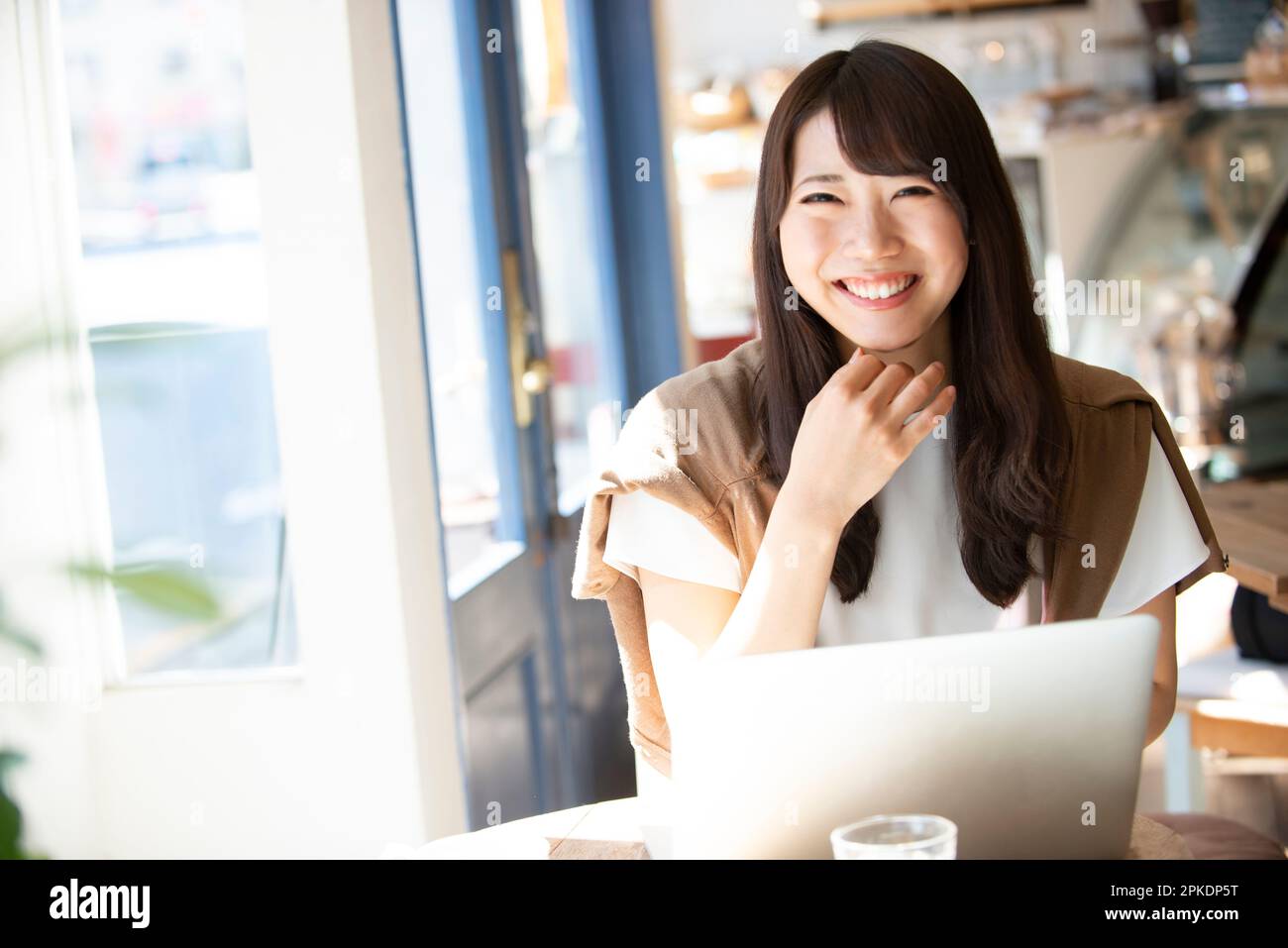 Woman laughing at a café Stock Photo