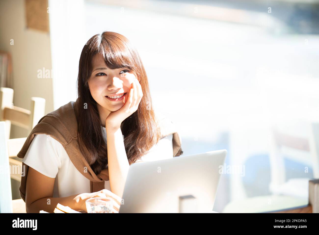 Woman working with a computer at a café Stock Photo
