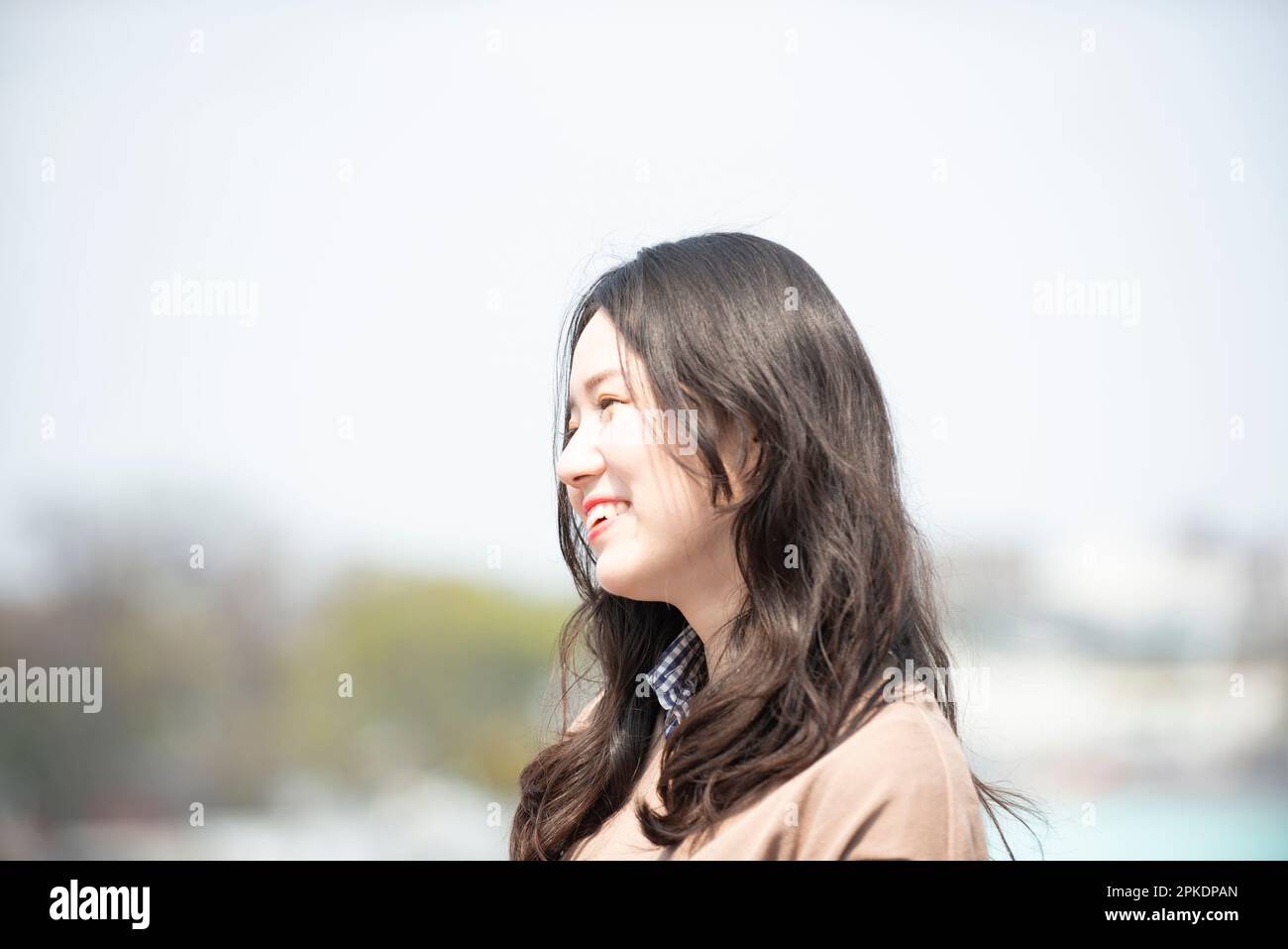 Woman laughing on rooftop Stock Photo