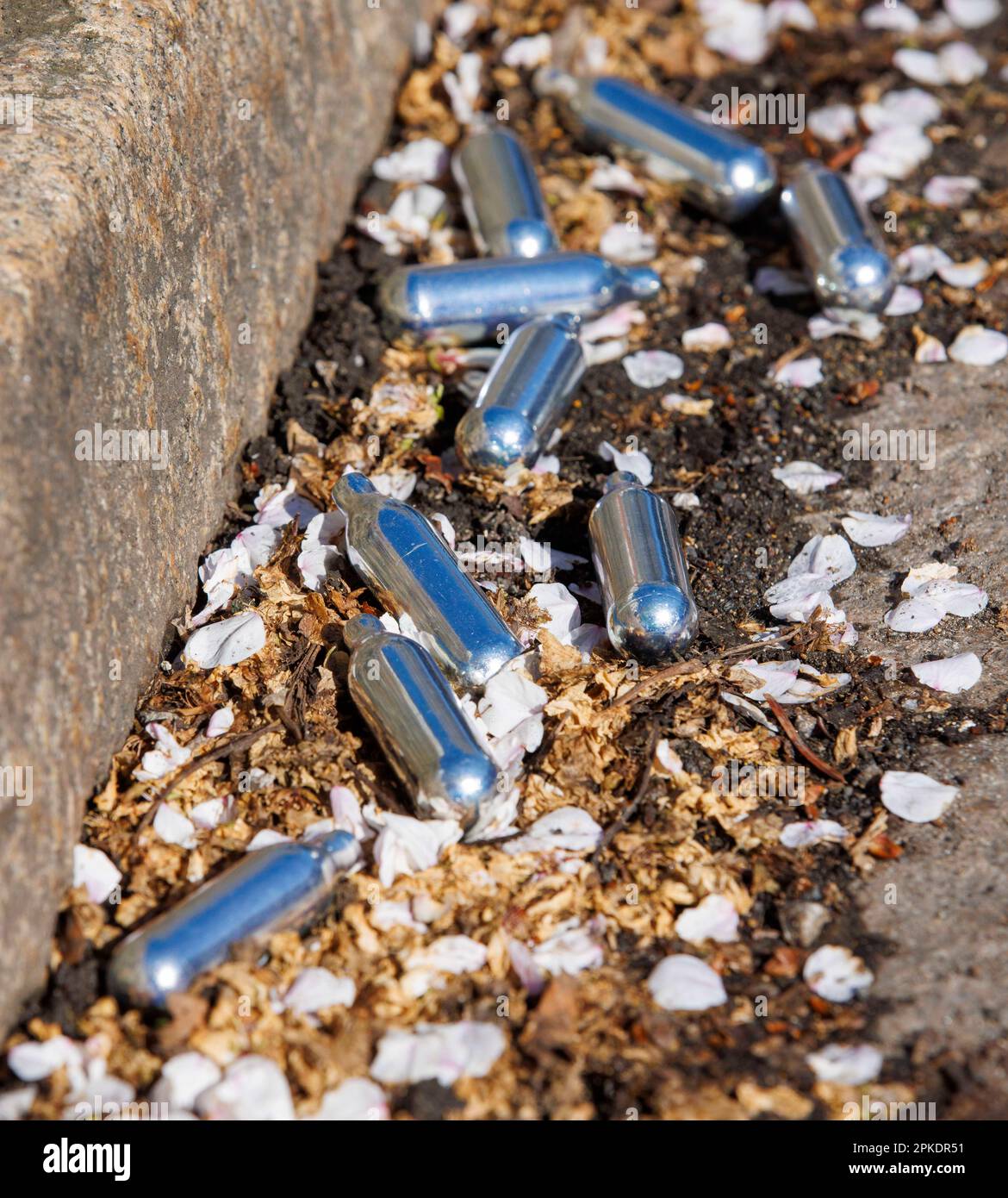 London, UK. 7th Apr, 2023. Canisters of Nitrous Oxide in a street in West London. The sale of