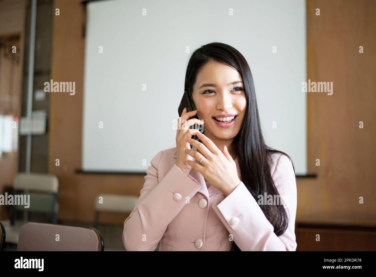 Woman on phone in office Stock Photo