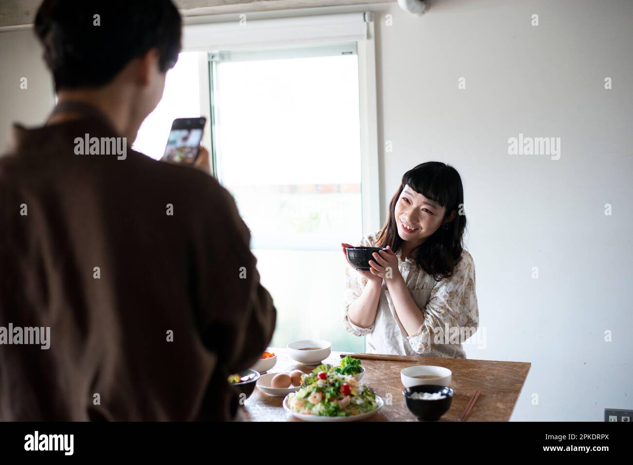 Couple taking a picture of breakfast with a smartphone Stock Photo