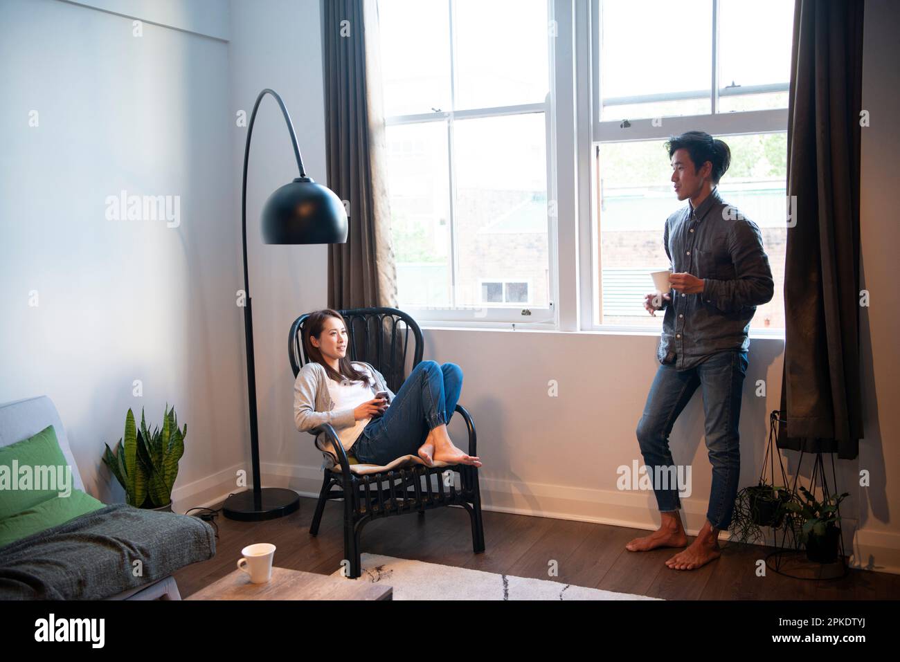 Couple relaxing in the living room while talking Stock Photo