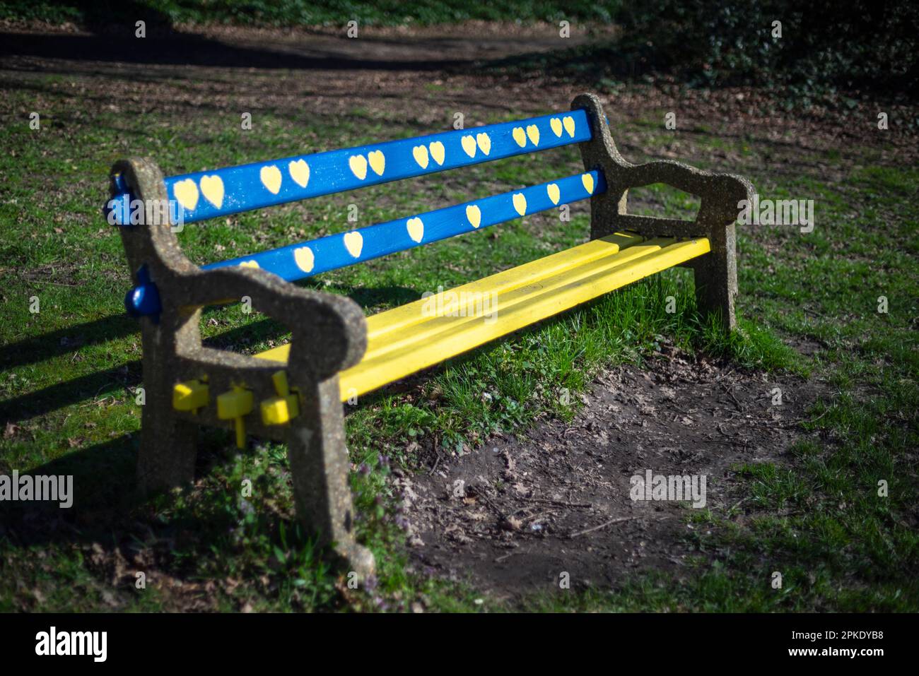 A bench painted in the national colours of Ukraine, blue and yellow - love for Ukraine concept, Southampton, England, UK Stock Photo