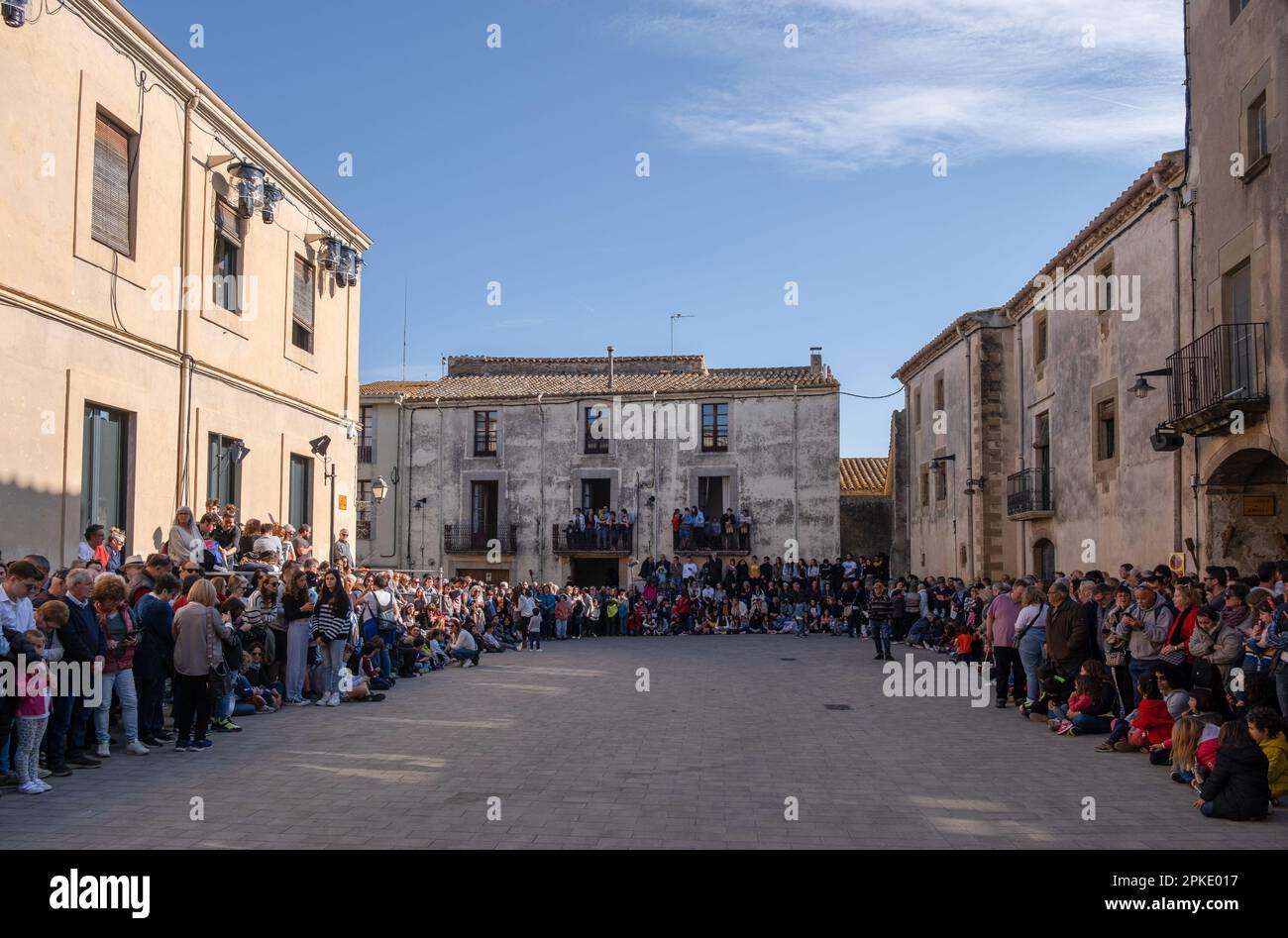 Verges, Spain. 06th Apr, 2023. A group of people wait in the town square for the start of the Les Manages procession. Traditional Easter Week parade in Verges (Girona) with Les Manages, a procession of men and since two years now, also women, dressed as armed Roman soldiers. During the procession through the streets of the town, the soldiers collect the religious images to take them to the church. Credit: SOPA Images Limited/Alamy Live News Stock Photo