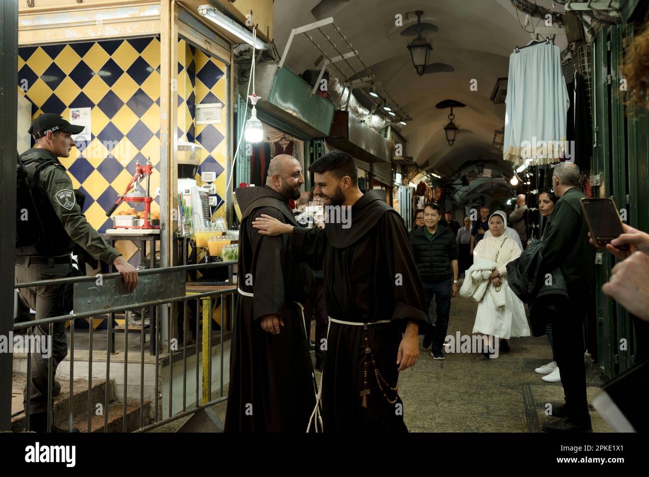 Priests greet each other on a procession along the Via Dolorosa, a ...