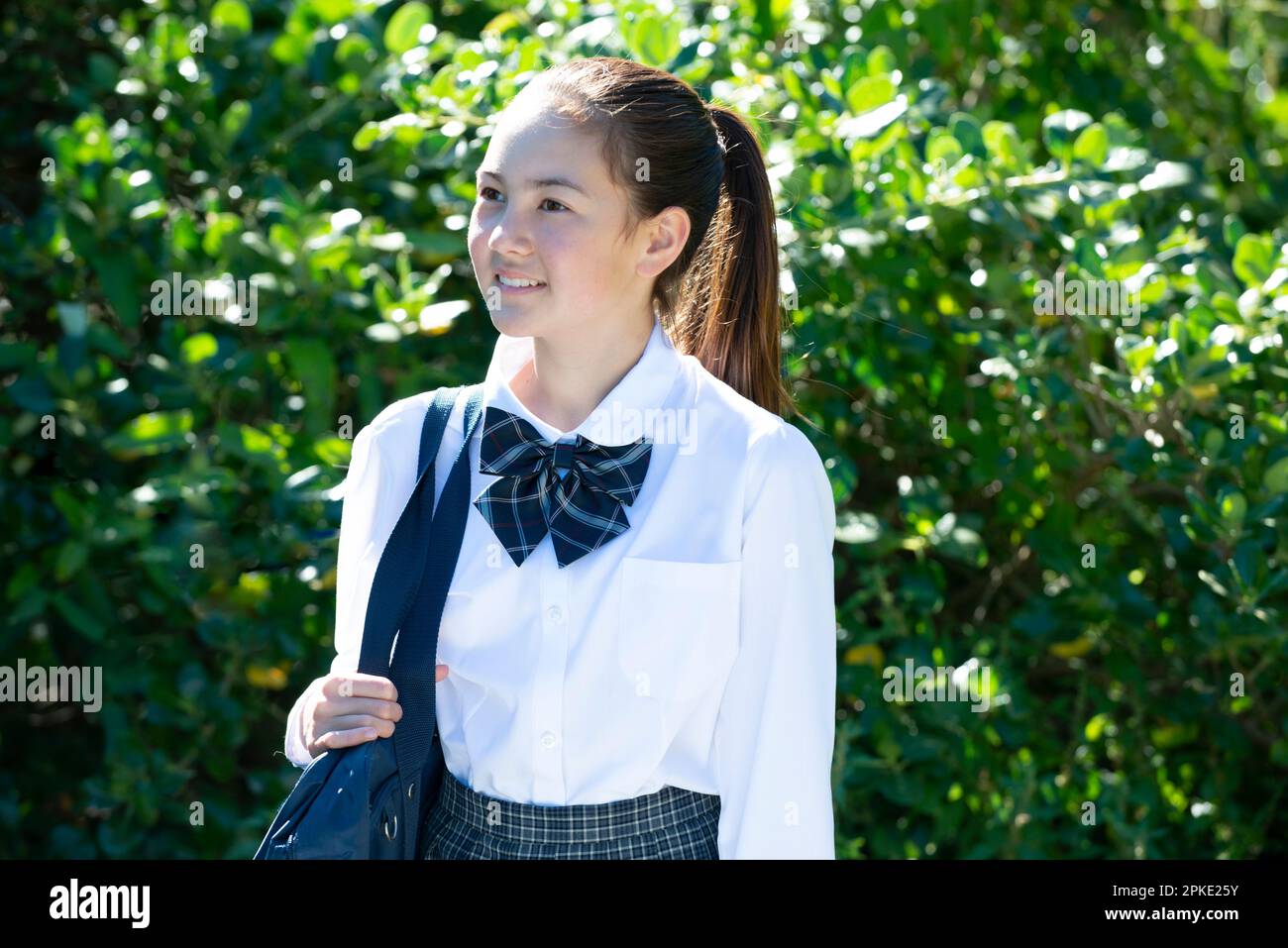 Female student in school uniform smiling Stock Photo - Alamy