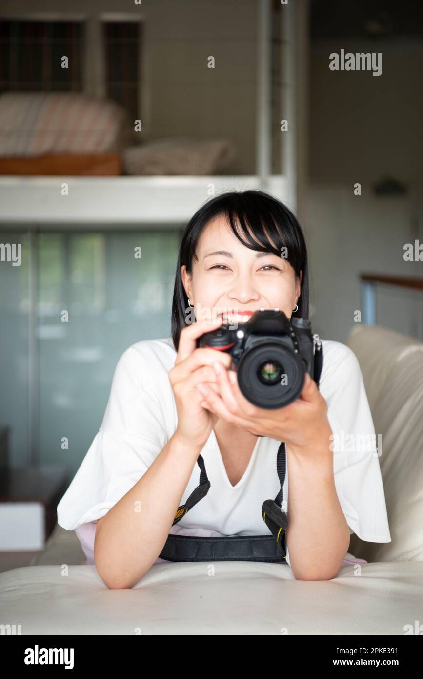 Woman laughing with an SLR camera Stock Photo
