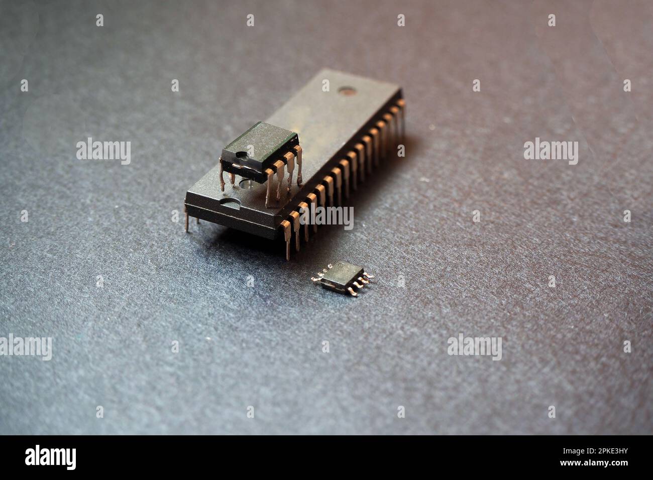 Integrated circuits and microchips on black background. Semiconductor componenets. Through-hole and surface-mount chips. Stock Photo