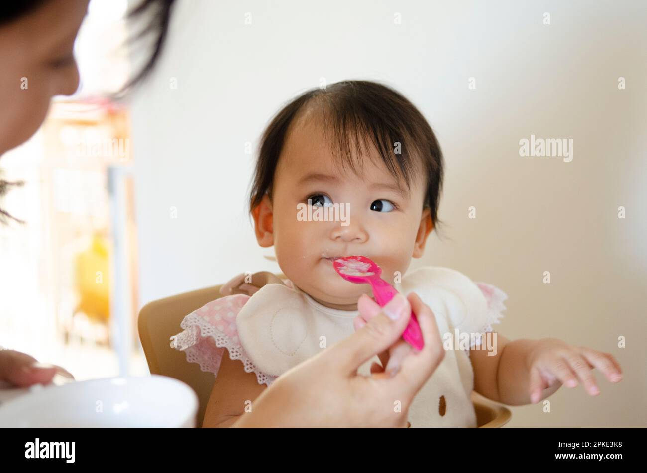 Baby eating baby food Stock Photo