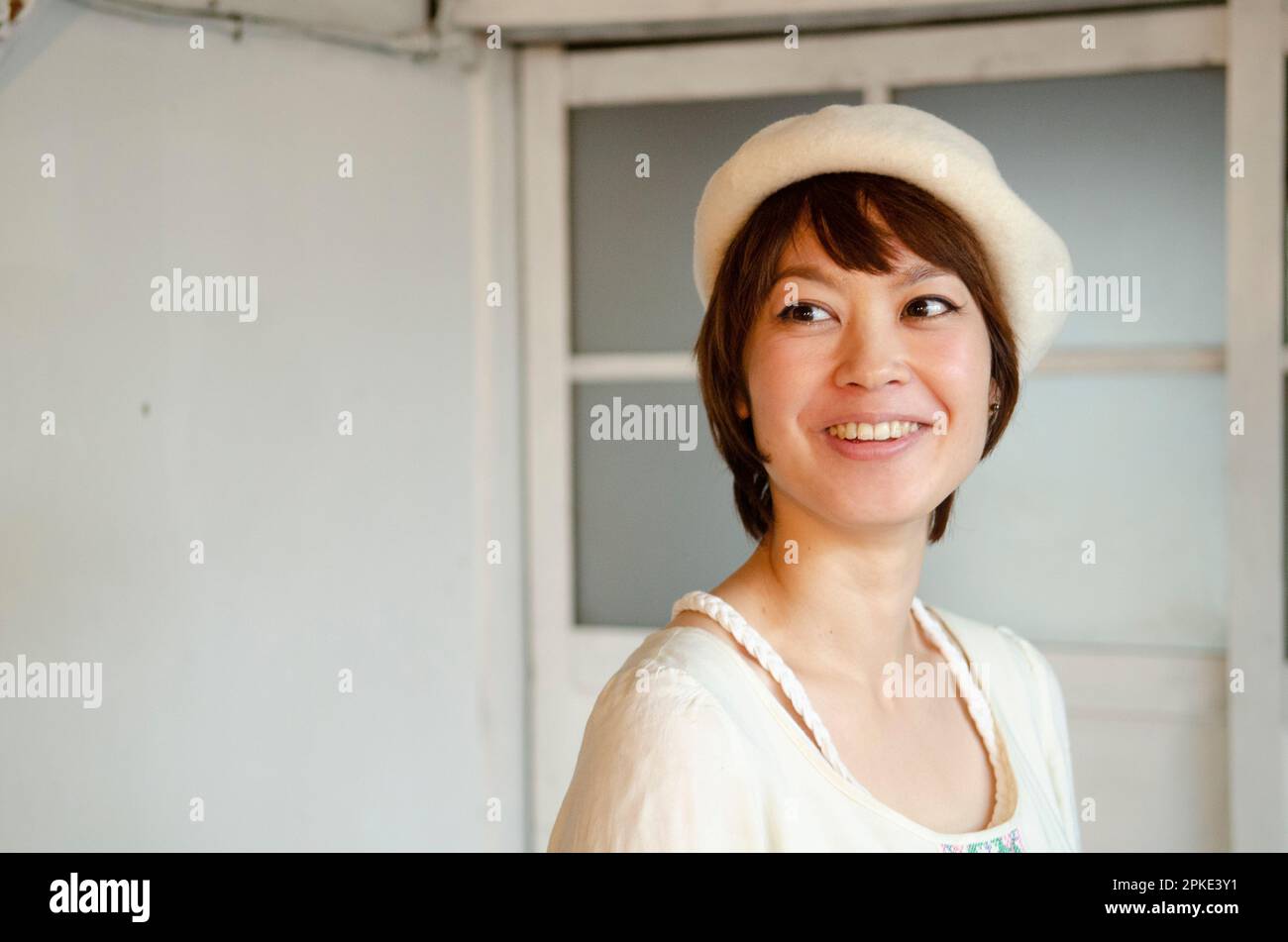 Woman laughing wearing a beret Stock Photo