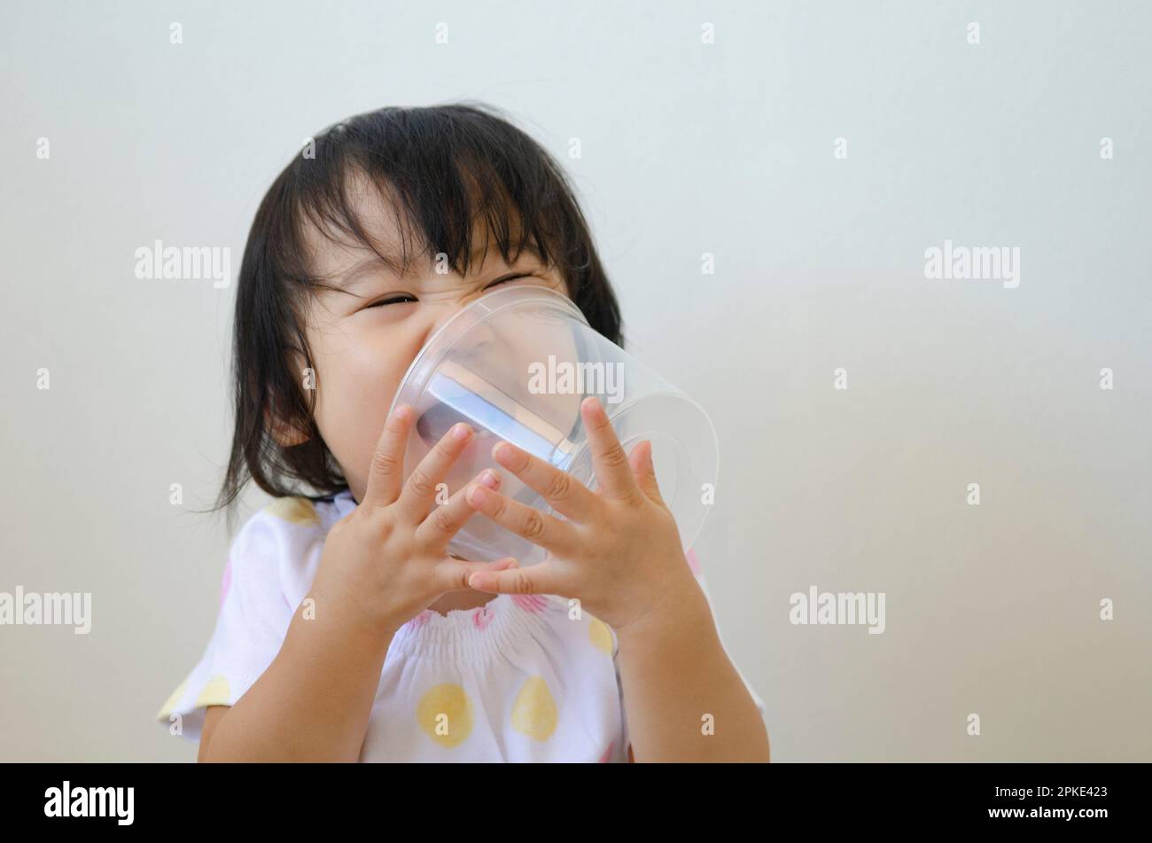 Girl laughing with plastic cup Stock Photo