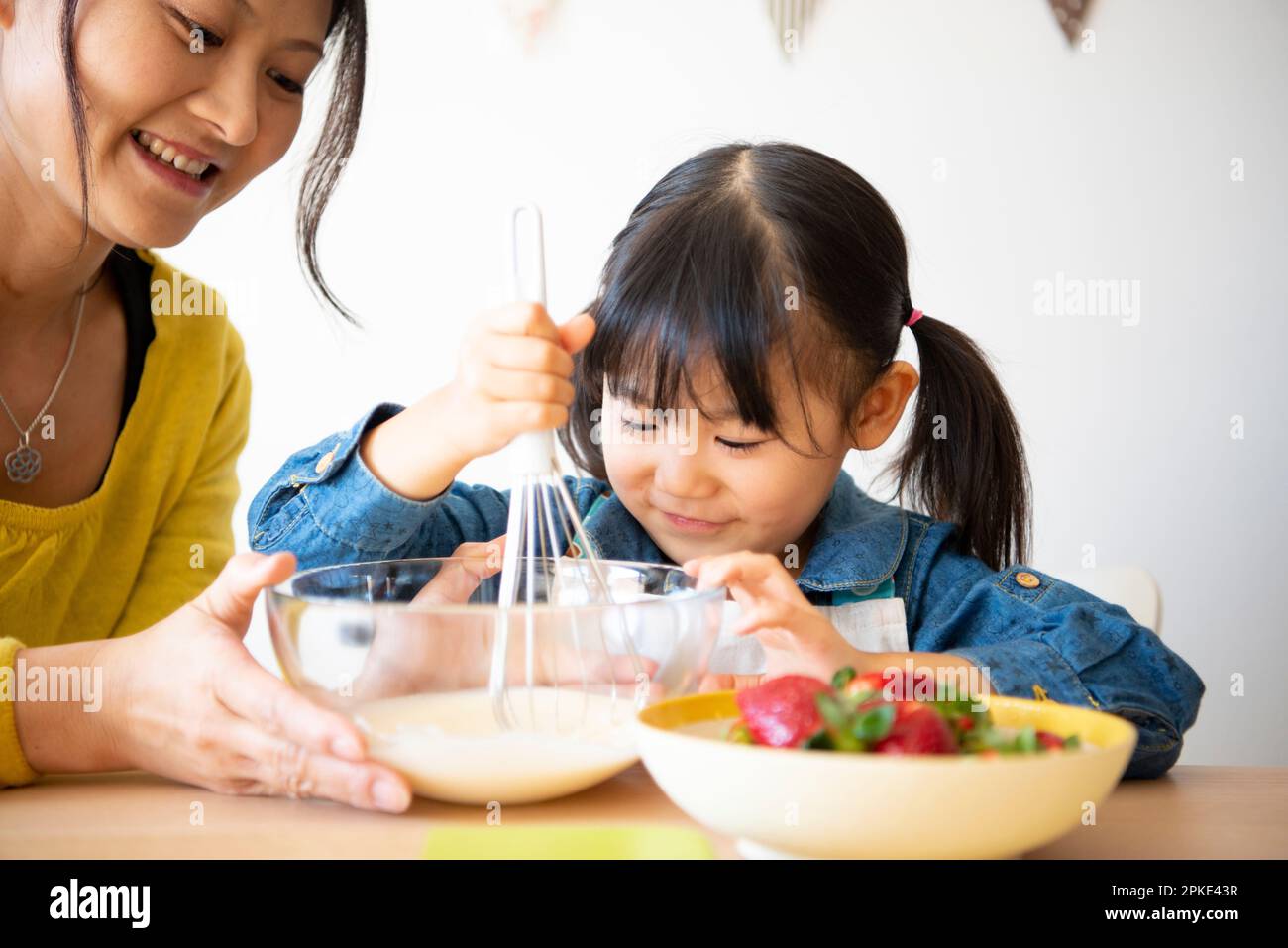 Parent and child making snacks Stock Photo