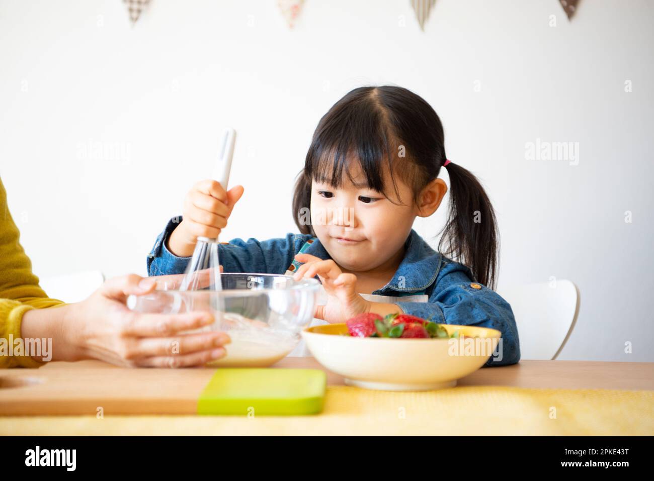 Parent and child making snacks Stock Photo