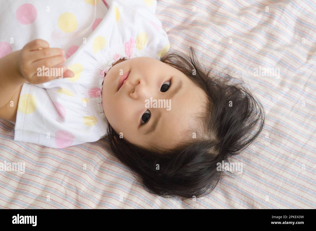 Girl lying on bed Stock Photo