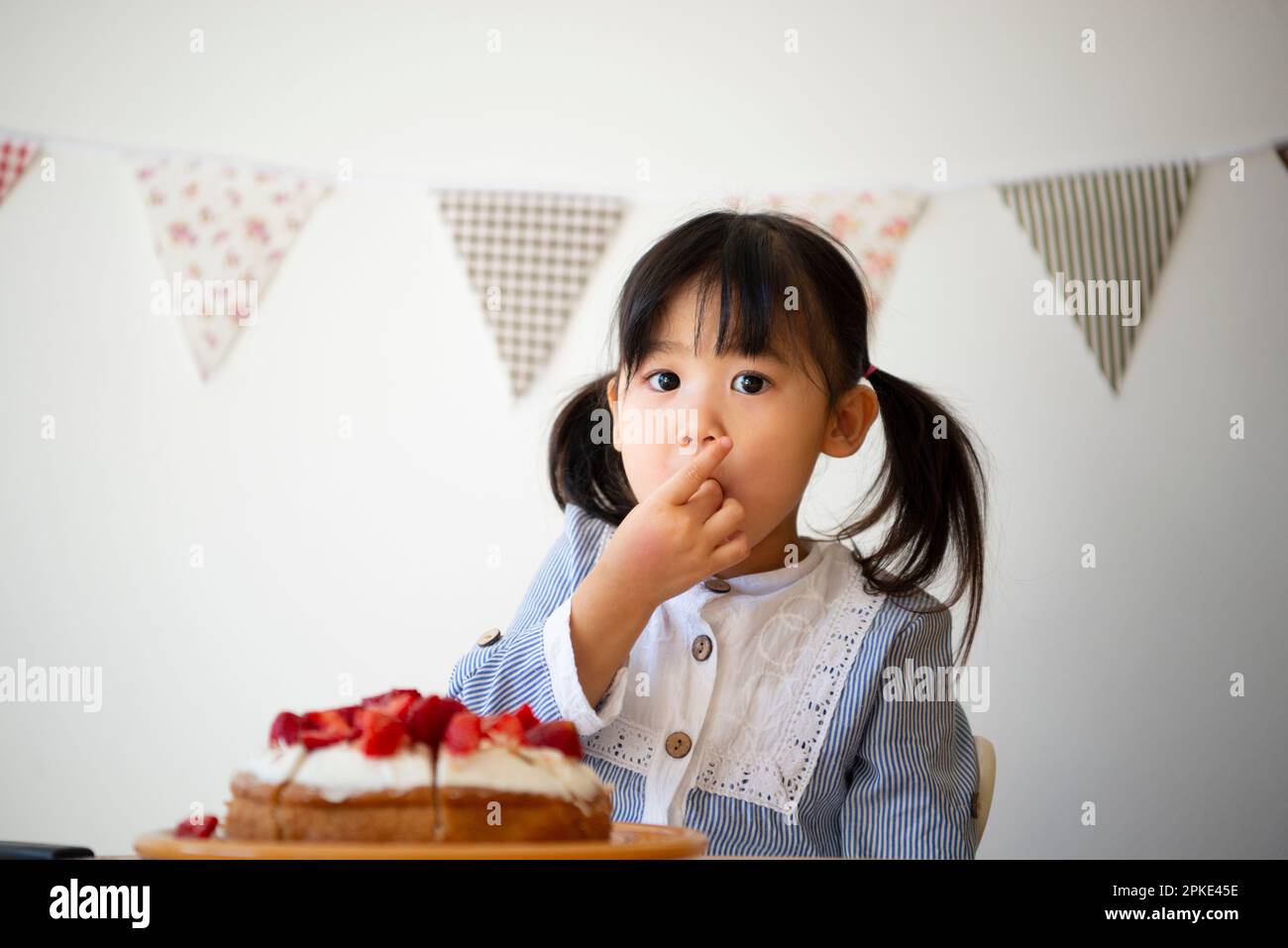 Girl eating cake strawberries Stock Photo