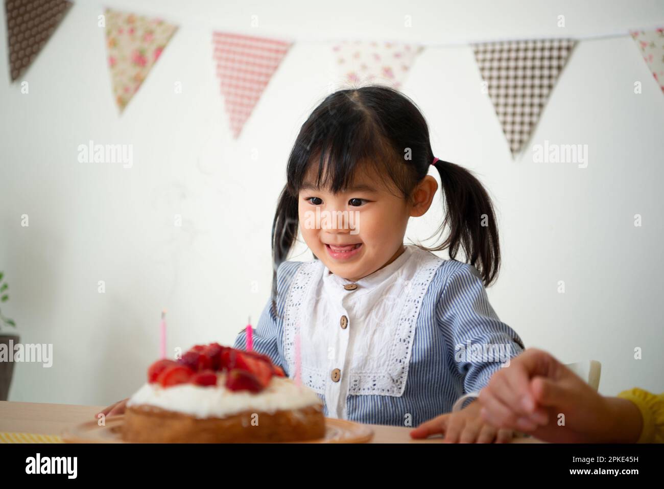 Girl looking at cake Stock Photo