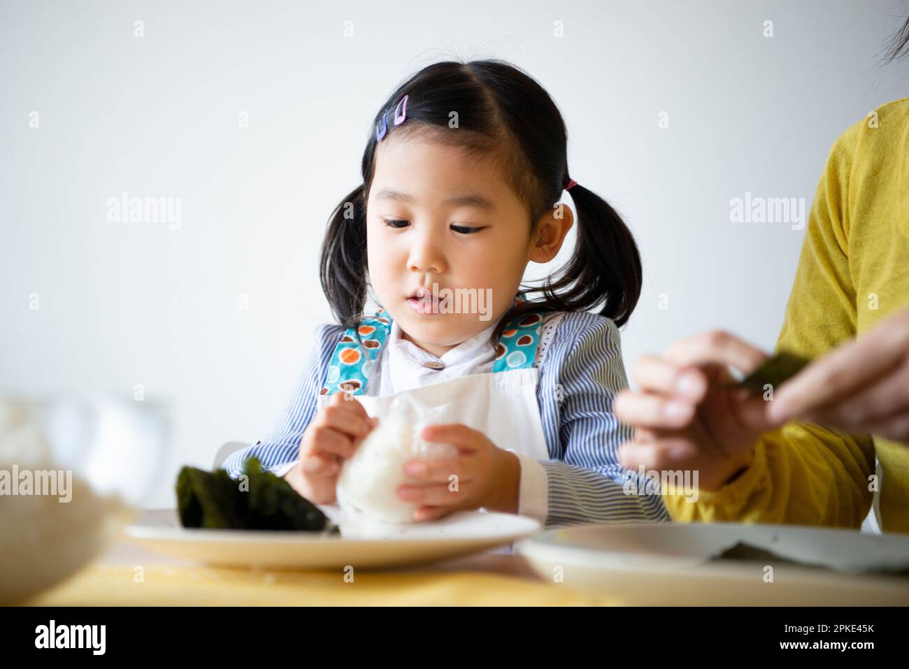 Girl making onigiri Stock Photo