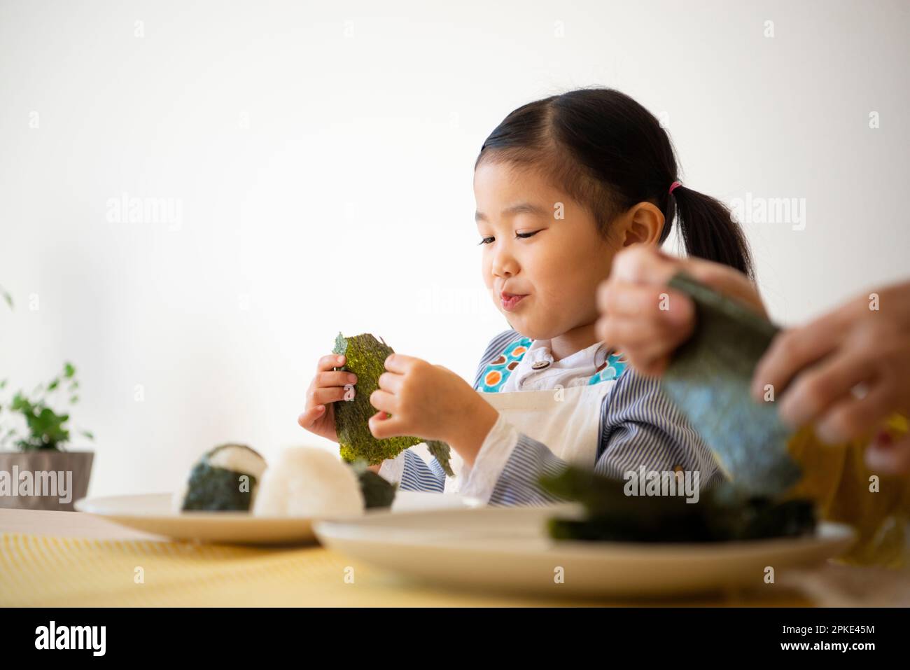 Girl making onigiri Stock Photo