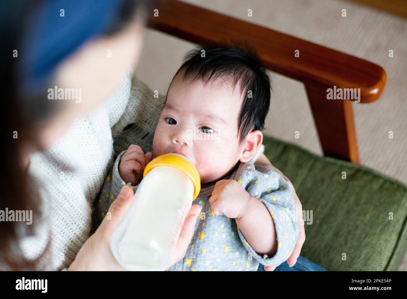 A 2-year-old baby girl drinks a baby bottle of milk Stock Photo - Alamy