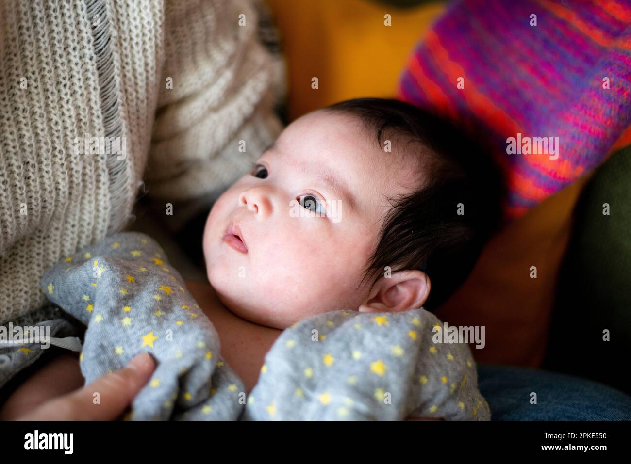 Baby staring at mother Stock Photo