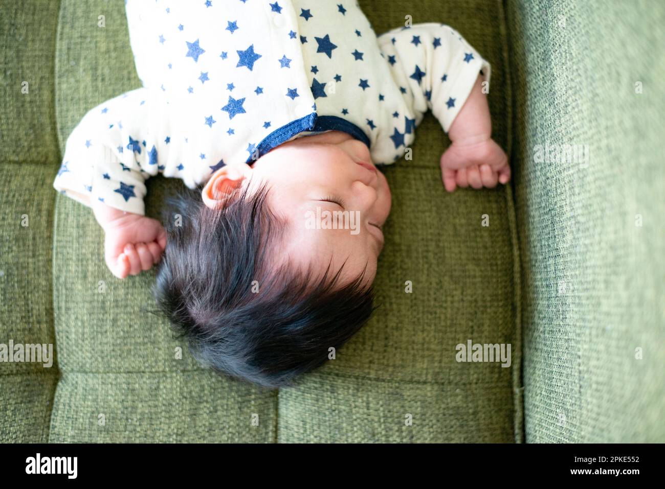 Baby sleeping on couch Stock Photo