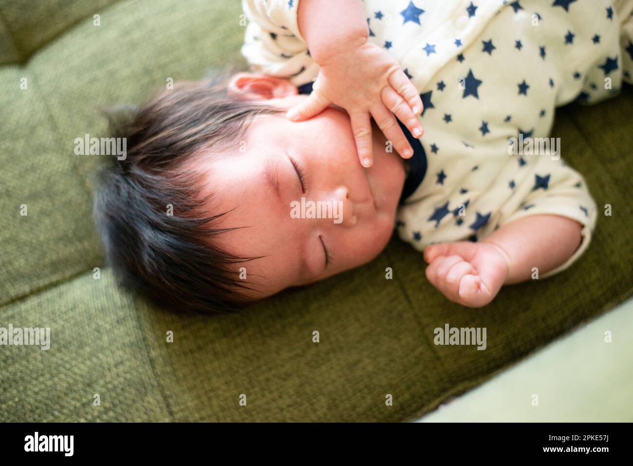 Baby sleeping on couch Stock Photo