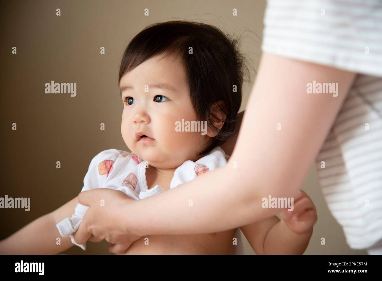 Baby getting dressed Stock Photo