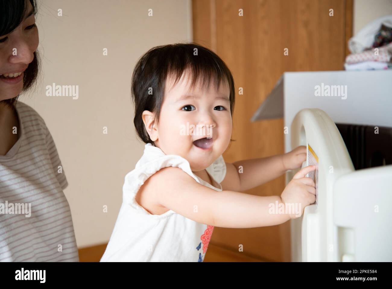 Baby standing on hands and feet Stock Photo