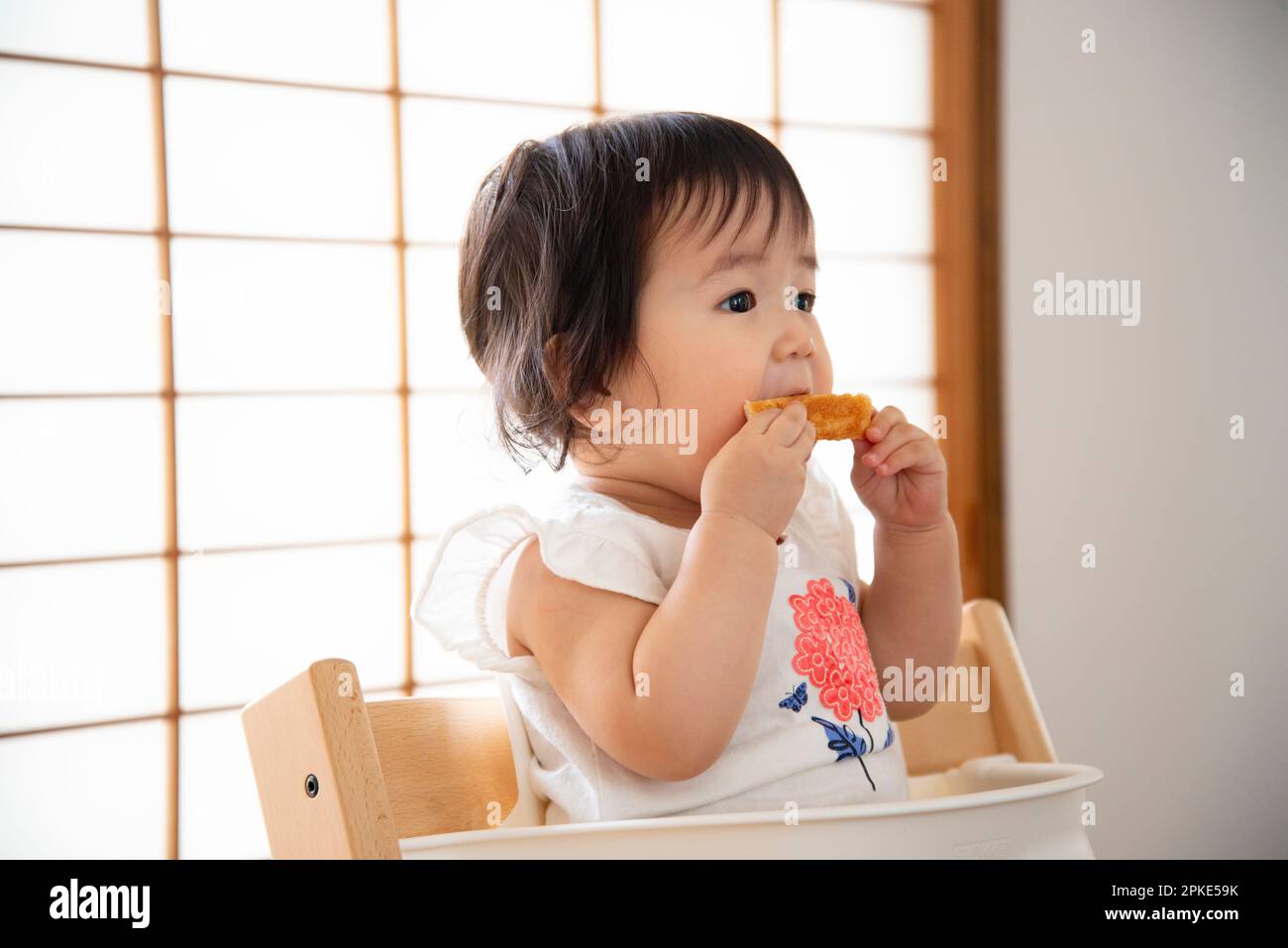 Baby eating bread Stock Photo