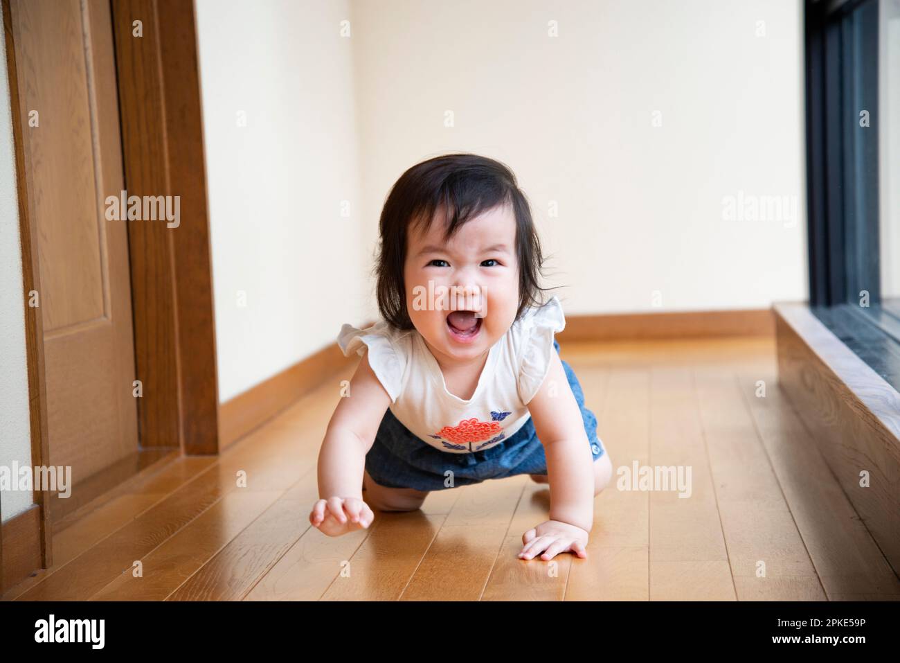 Baby crawling on the flooring Stock Photo