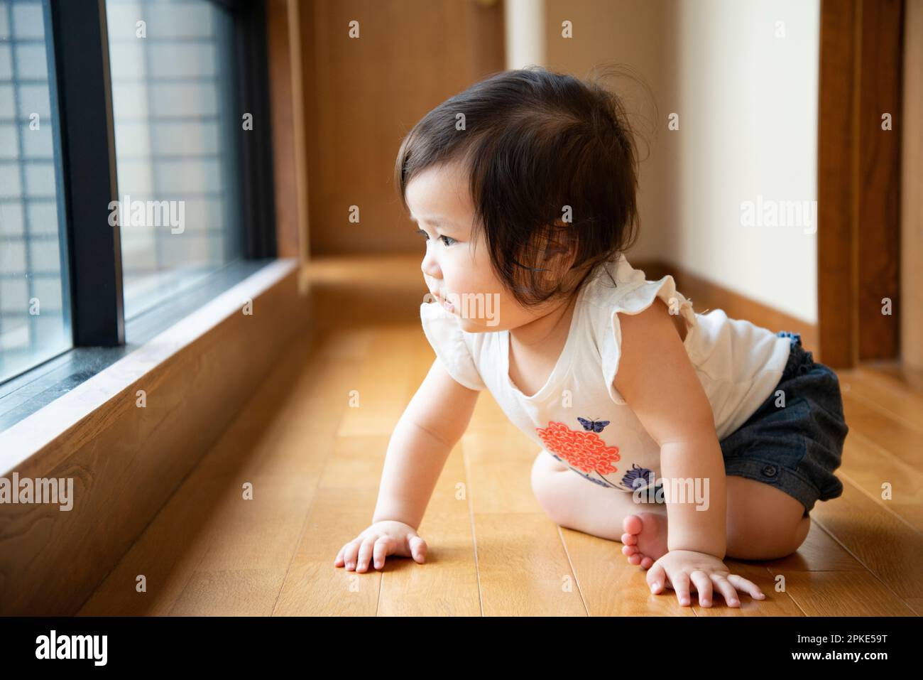 Baby crawling on the flooring Stock Photo