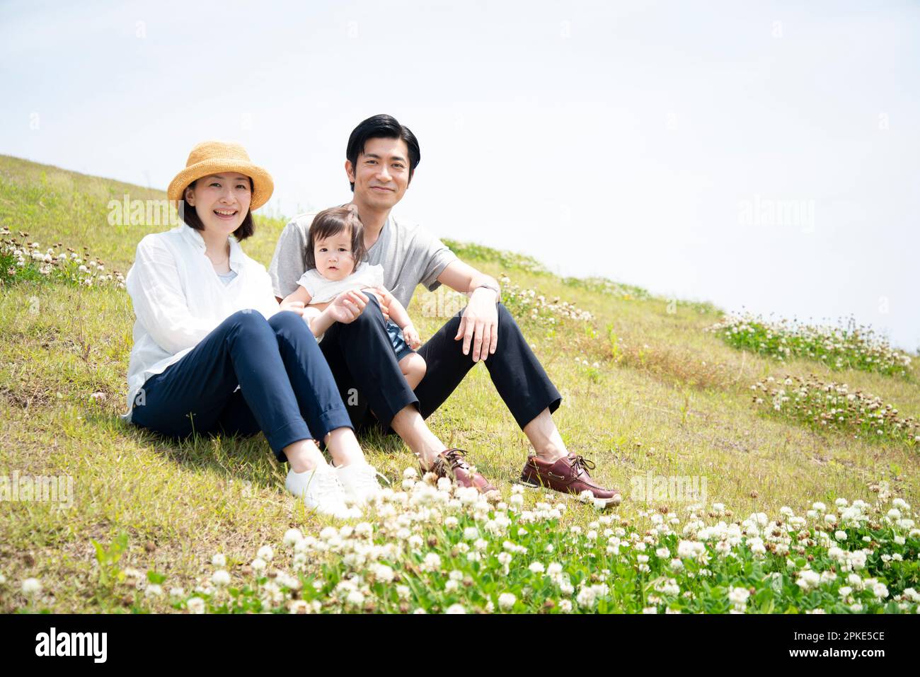 Family sitting on lawn Stock Photo