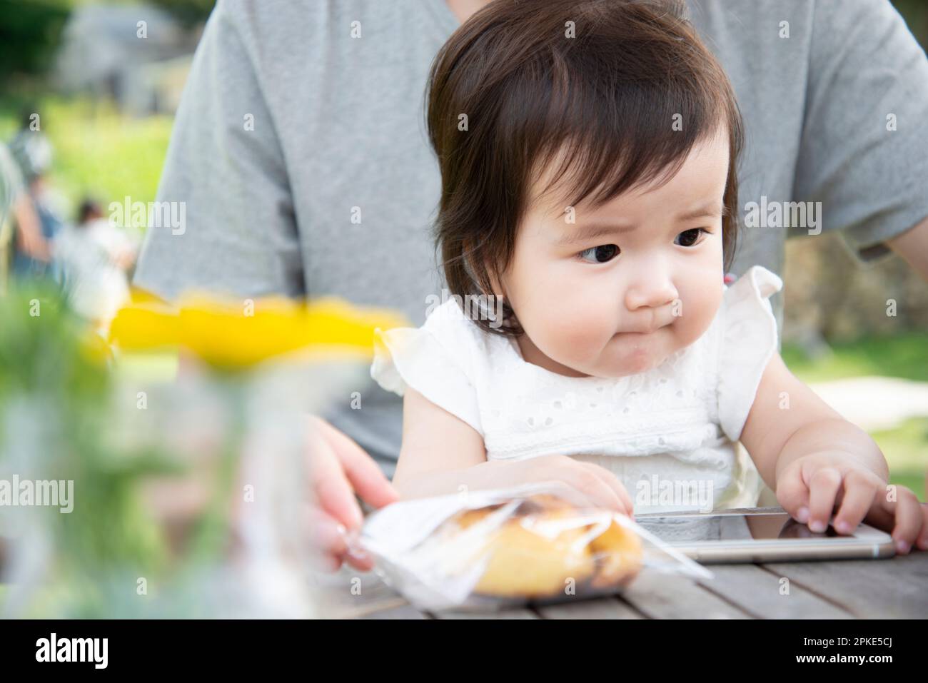 Baby touching a cell phone Stock Photo