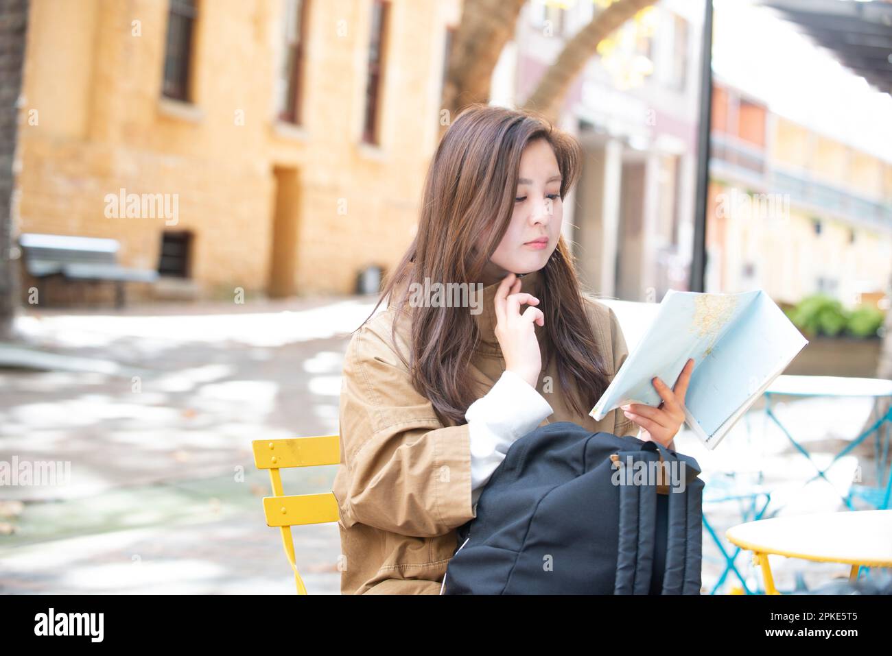 Woman sitting and looking at a map Stock Photo