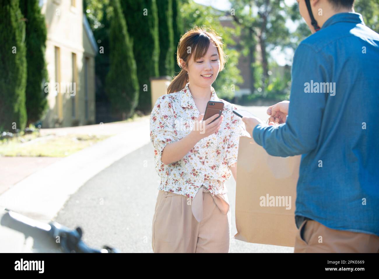 Woman receiving food delivery Stock Photo - Alamy