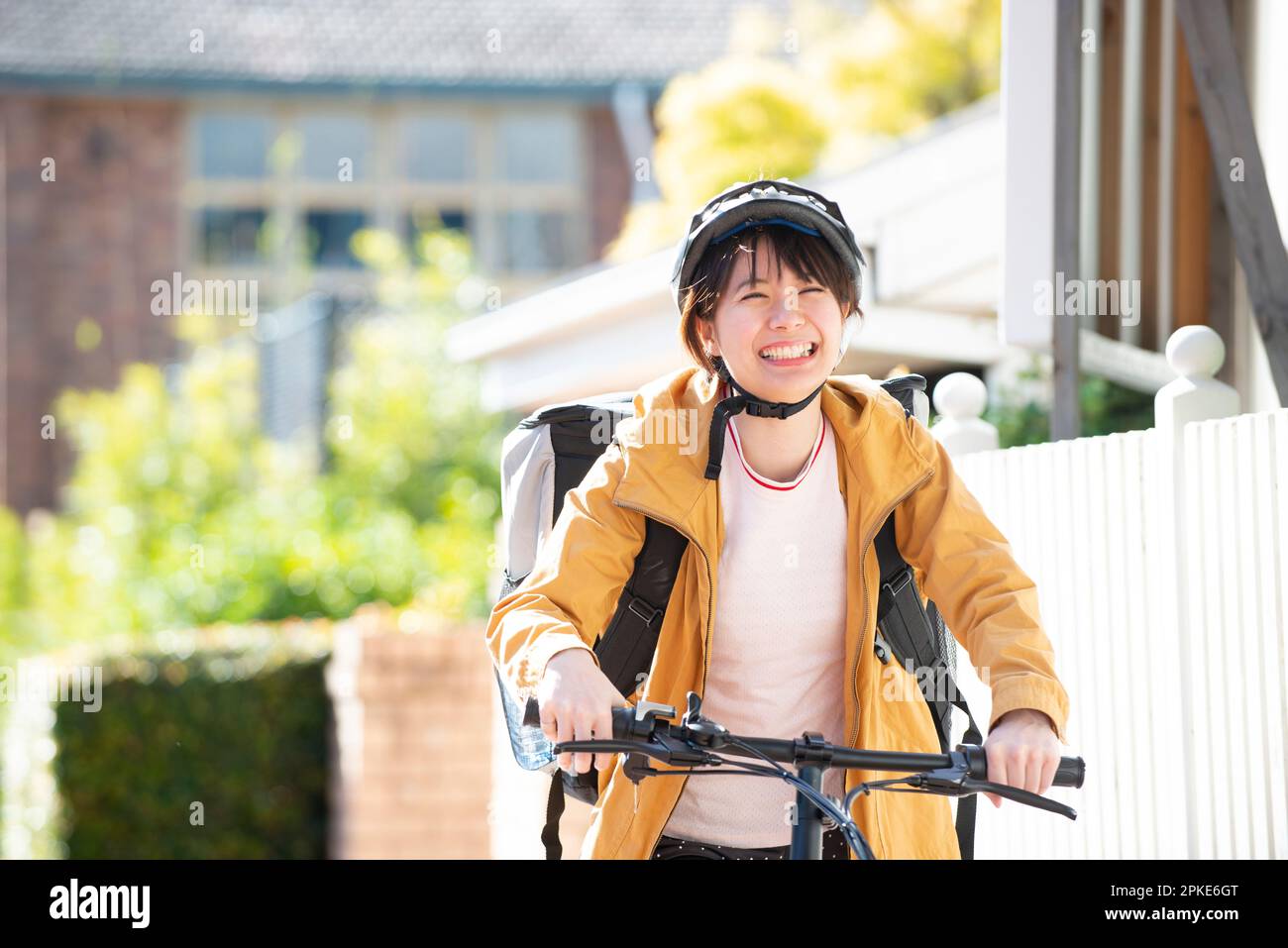 Food Delivery Woman on a Bicycle Stock Photo
