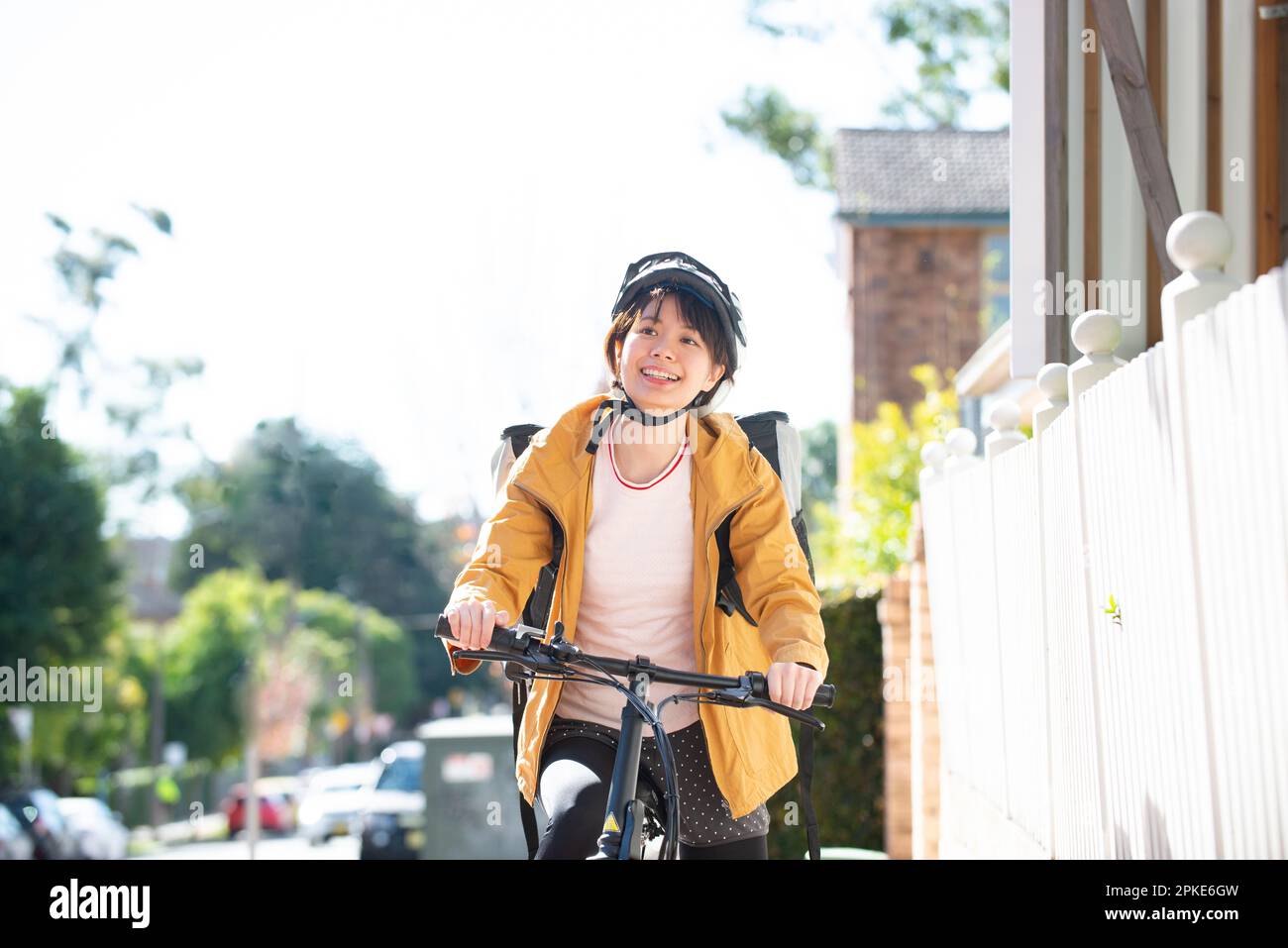 Food delivery woman on a bicycle Stock Photo
