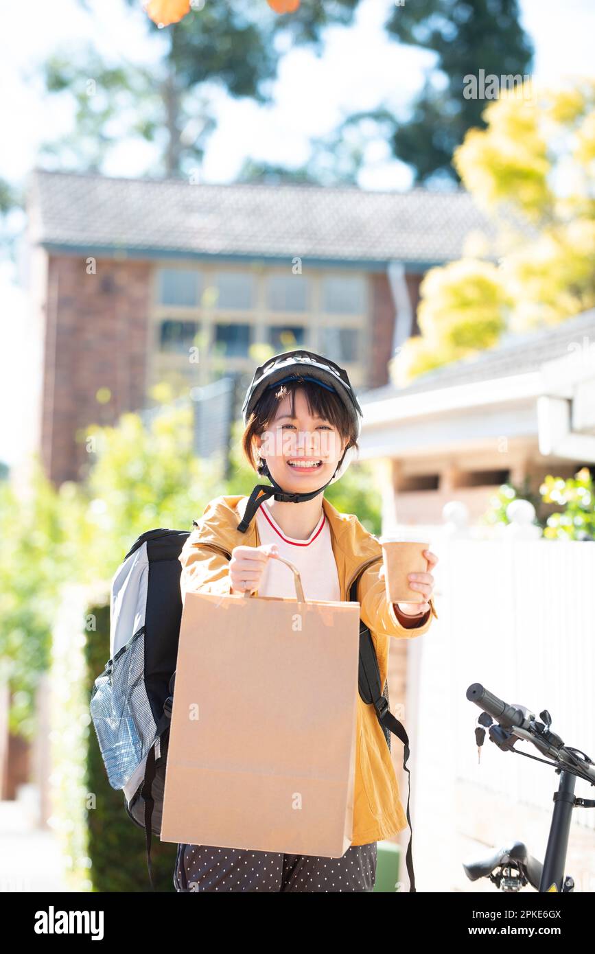 Food delivery woman offering food for delivery Stock Photo Alamy