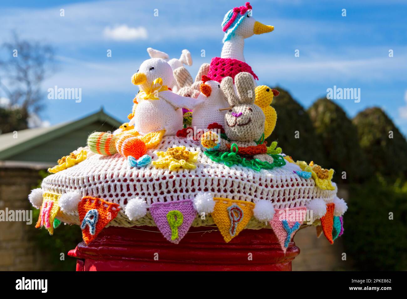 Poole, Dorset, UK. 7th April, 2023. An Easter themed knitted and crocheted postbox topper spreads Easter cheer on a lovely warm sunny Good Friday at the start of the long Easter Bank Holiday weekend.  - post box topper, letterbox topper, letter box topper, toppers, yarn bombing, yarn bomb. Credit: Carolyn Jenkins/Alamy Live News Stock Photo