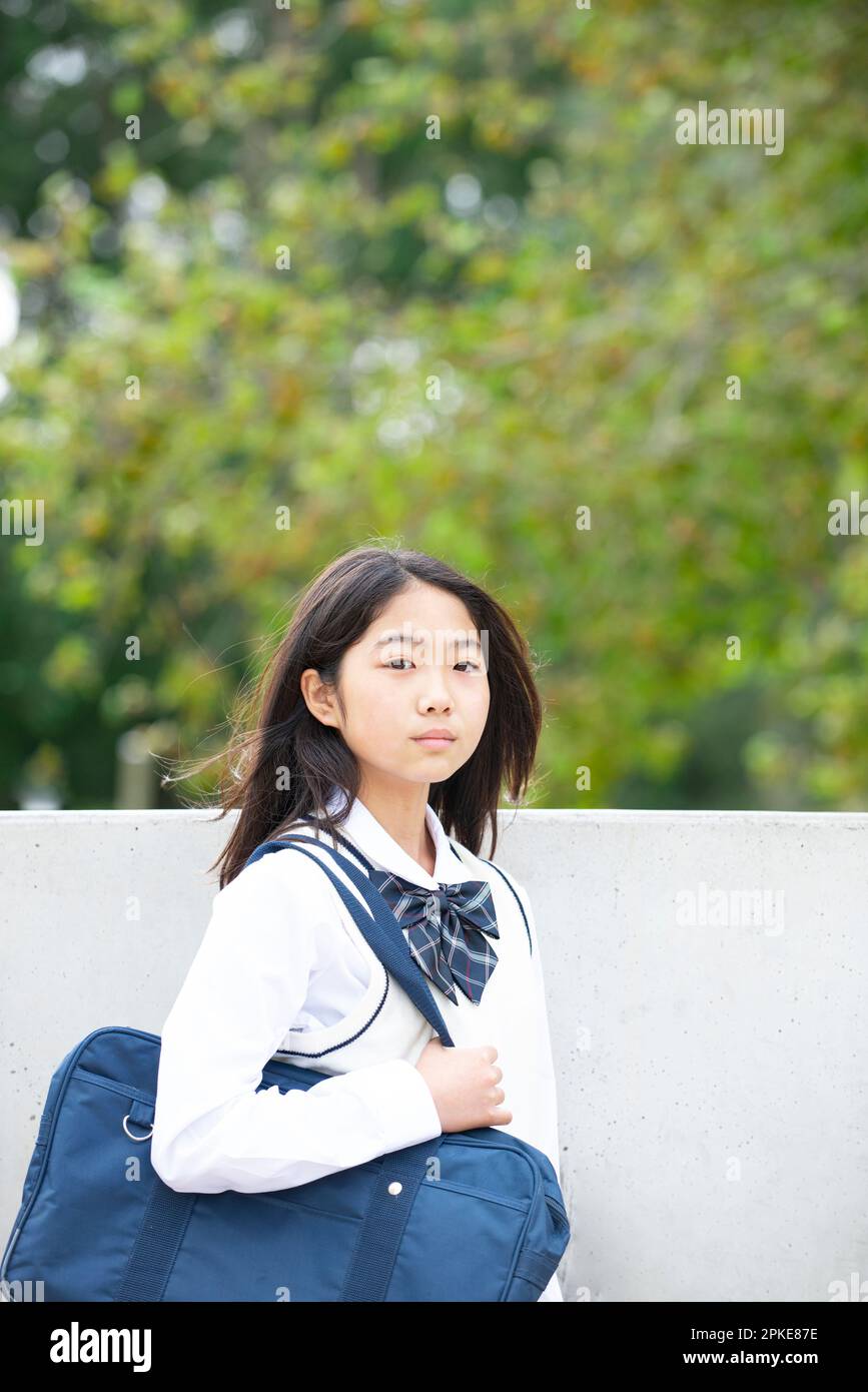Female student smiling at green background Stock Photo - Alamy