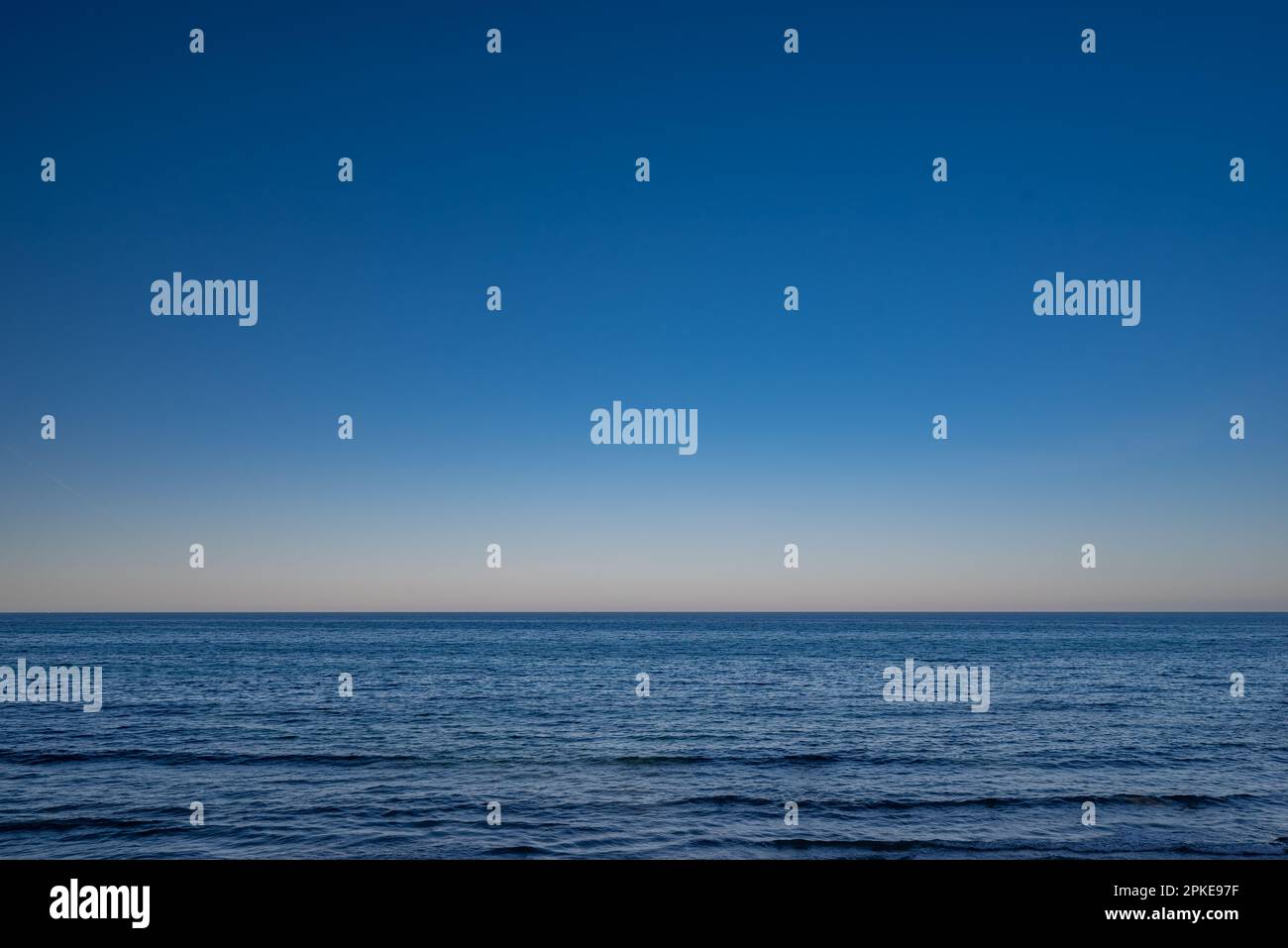 Blue ocean or sea background. Blue sky above calm water Stock Photo - Alamy