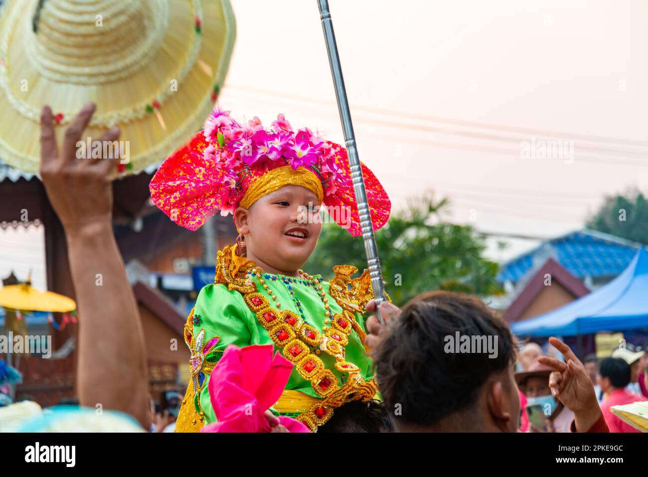 Pai,Mae Hong Son,Thailand-April 3rd 2023:Boys,aged between seven and fourteen years,about to be ordained as Buddhist monks,are carried on men's should Stock Photo
