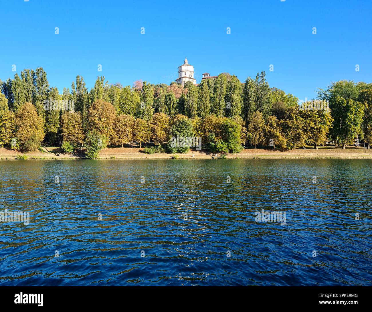 The river Po in Turin photographed by the Murazzi. On the river with the calm and blue waters, the Monte dei Capuccini rises on the Turin hill. Stock Photo