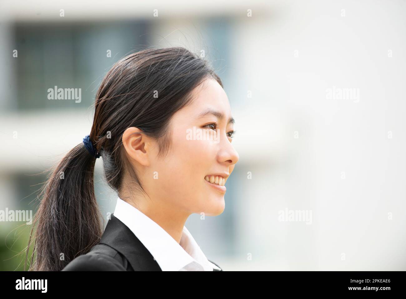 Woman in suit in profile Stock Photo