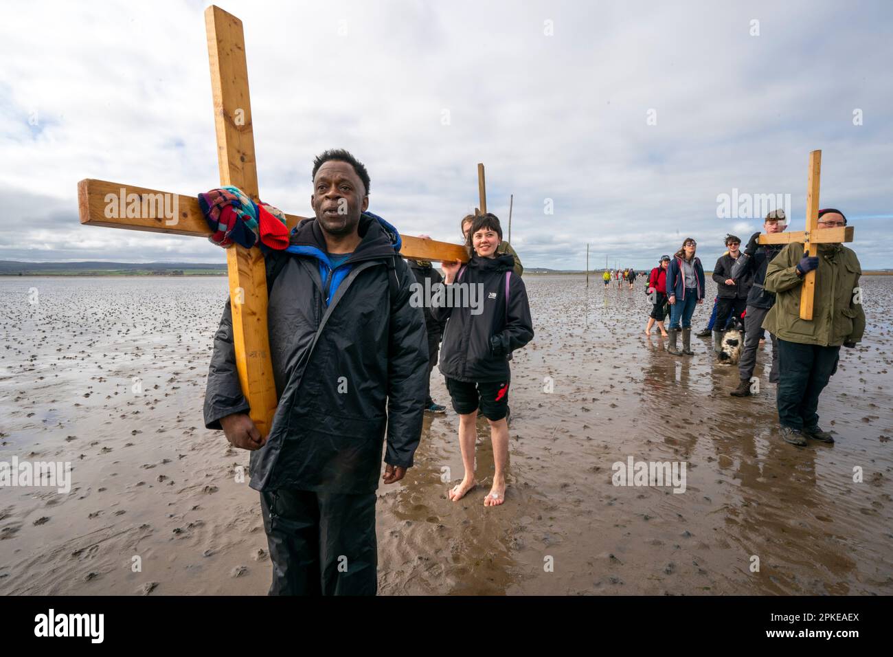 pilgrims-carrying-crosses-across-the-sands-to-the-holy-island-of