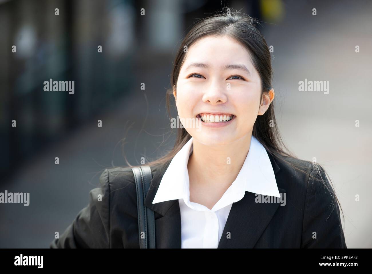 Woman in suit laughing Stock Photo