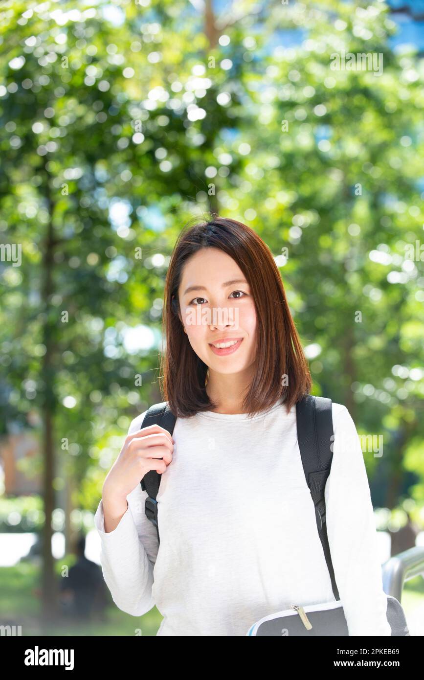 Female student looking at me with green background Stock Photo - Alamy